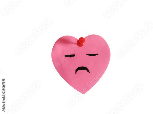 Sad pink heart shape sticky note with a push pin