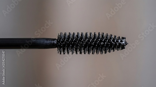 Plakat w ramie Close up of a black mascara wand isolated on a neutral background.