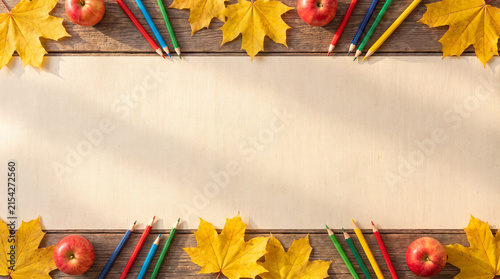 Autumn back to school frame background with leaves pencils and copy space