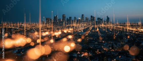 A futuristic cityscape glows with digital connections and bokeh lights at dusk