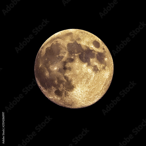 Detailed closeup view of a full moon with visible craters and textures in night sky