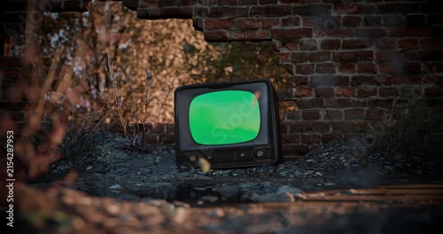Vintage TV green screen with noise effect mockup in an abandoned post-apocalyptic ruin. Looped video