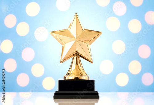Golden star trophy award on a black base with colorful bokeh lights background perfect for success celebration