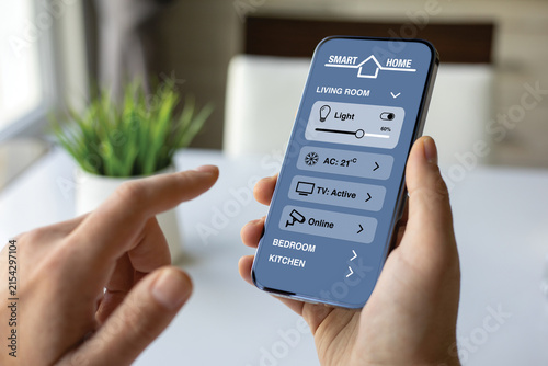 Man hand holding smartphone with Smart Home control application Interface