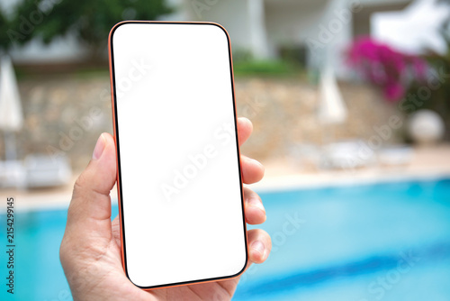 Man hand holding phone isolated white screen mockup beach pool