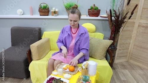 Woman eating a slice of orange