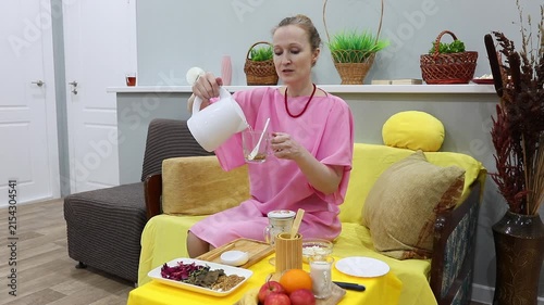 woman pouring boiling water over Buckwheat tea Ku Qiao in a mug