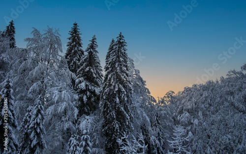 Suggestive winter sunset with orange and purple shades that light up the mountain top