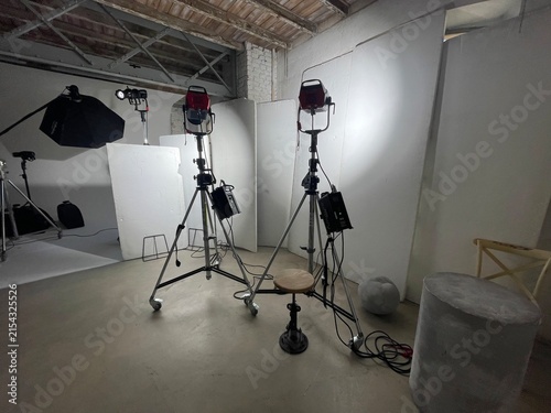 Empty photography studio with lighting equipment and backdrop