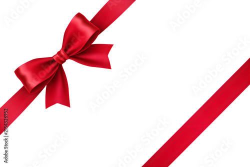 Elegant red ribbon bow with flowing ends against a black background for gift giving and festive celebrations