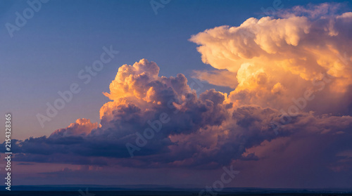 фотографія Majestic cloudscape at sunset above a wide expansive landscape with dramatic cumulus formations and vivid colors