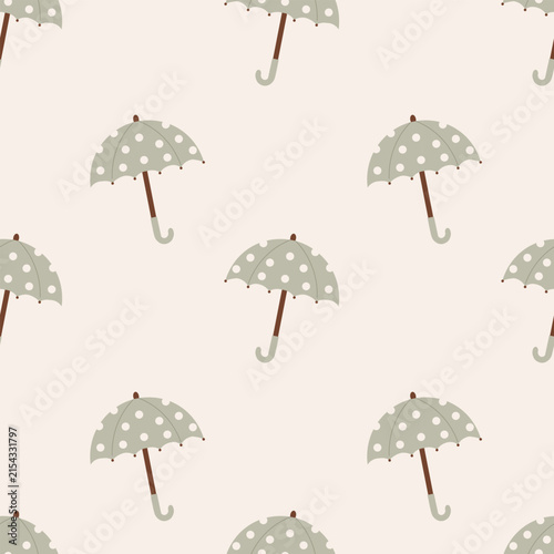 Seamless pattern with sage green polka dot umbrellas on beige background. Autumn rainy weather print ideal for cozy nursery decor, apparel, wallpaper, wrapping paper, and textiles.
