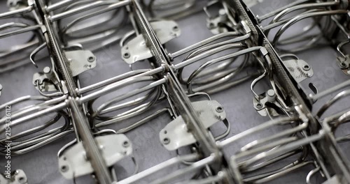 Close-up of metal parts being meticulously arranged in a workshop. Hands skillfully position each piece, showcasing craftsmanship and precision as they prepare for assembly and design.