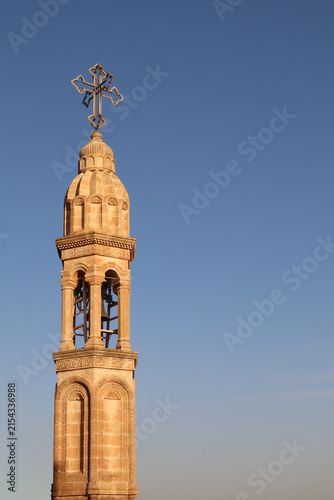 Photography Historic Christian Bell Tower with Ornate Cross Against Clear Blue Sky