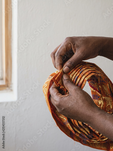 Hands Folding Vibrant Gele Headwrap Fabric, Lagos Nigerian Fashion