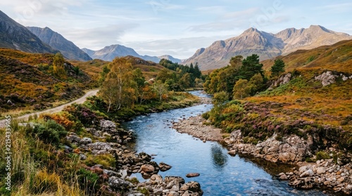 Scottish Highlands River Scene: A breathtaking vista unfolds with a winding river carving its path through the rugged, autumn-kissed landscape of the Scottish Highlands.