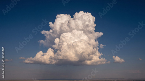 Konstfotografi Majestic cumulus cloud formation dominating a vast blue sky, a powerful symbol of nature's beauty and potential weather