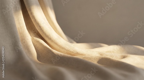 Foto Sunlight Illuminating Flowing Linen Textile - Close up of draped natural beige l