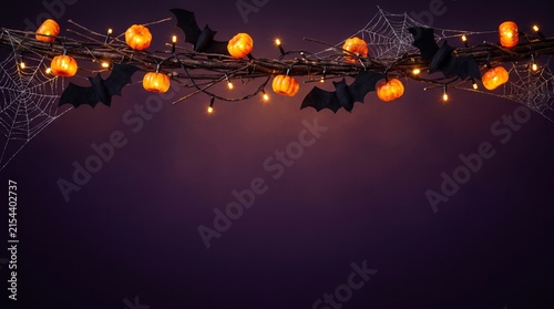 A festive halloween background featuring a string of glowing orange pumpkin lights against a dark purple and moody backdrop