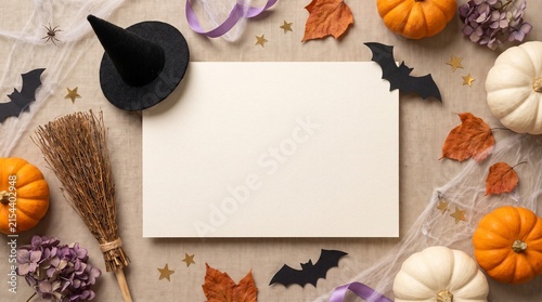 A blank paper sheet surrounded by pumpkins witch hat and autumn leaves for a festive halloween holiday background design