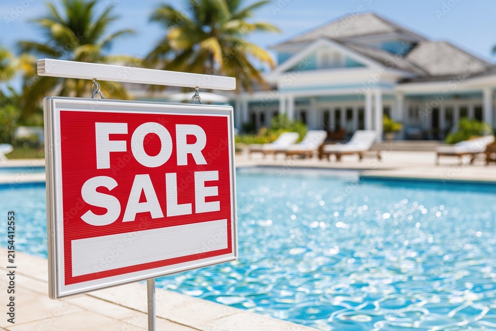 Fototapeta premium Luxury Tropical Villa with For Sale Sign by Sparkling Pool and Palm Trees