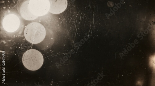 Abstract vintage monochrome light flares overlay texture with a grainy surface dark pattern horizontal wallpaper layout concept