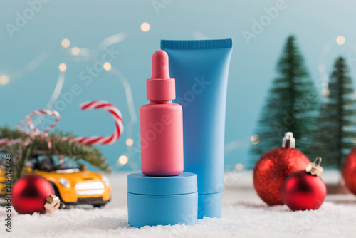 Skincare products with Christmas decorations and winter holiday background