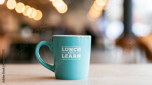 Turquoise coffee mug featuring lunch and learn text, representing business education, training, and professional development
