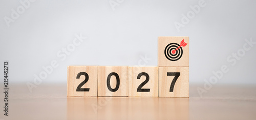 Bild auf Leinwand The concept of planning goals for 2027 uses a wooden cube with the number 2027 and dart symbols