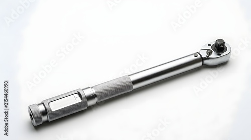 Torque wrench lying on a plain background