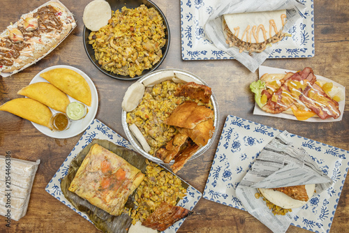 Fotografía Full Spread of Colombian Street Food: Lechona, Empanadas, Tamale, Arepas, and Lo