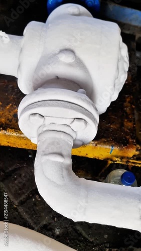 Heavy frost and ice accumulation on industrial cryogenic valve and flange pipe connection due to extreme low temperature gas flow