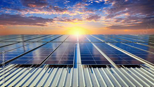 Solar panel array generating renewable energy at sunset