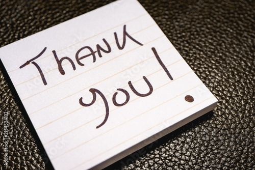 A handwritten note with the text Thank You  on it.