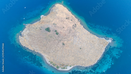 Foto Aerial View of Small Arid Island Surrounded by Turquoise Sea