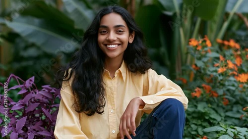 Young woman portrait in lush botanical garden with yellow shirt for natural outdoor portrait background and lifestyle banner design