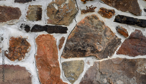 Bild auf Leinwand Close up of a multi color rock and mortar wall surface with porous, rough, uneve