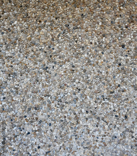 Canvas Print A vertical close up of decorative pebble embedded concrete pavement with smooth