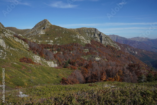 View of Lago Nero surrounded by autumn foliage on the mountain slopes in Abetone Cutigliano, Tuscany, Italy.