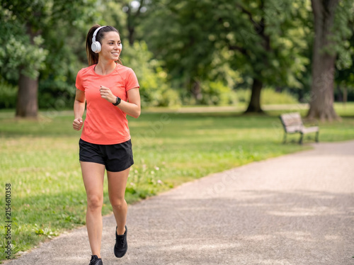 Young fair white woman jogging outdoors for weight loss fitness wellness exercise motivation healthy lifestyle and preventive healthcare advertising campaign