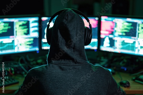 Plakat Hacker in a hoodie working on digital coding and security to commit cybercrime