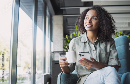 Businesswoman texting on mobile phone in modern office, Young student woman using smartphone at cafe. Online communication, business lifestyle, work or study connection, mobile apps, technology