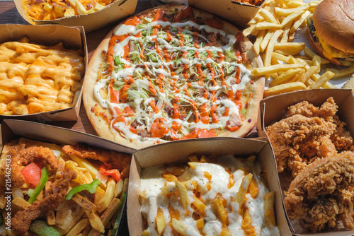 Doner kebab pizza surrounded by fried chicken, loaded fries and cheeseburger