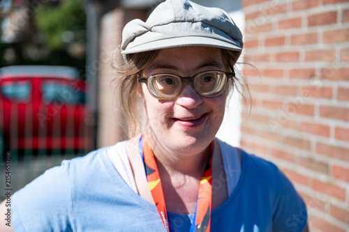 Portrait of a cheerful 43-year-old woman with Down syndrome