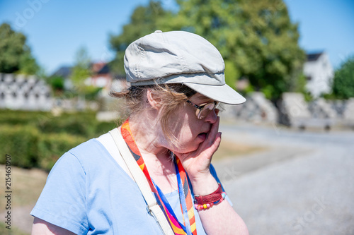 Woman mourning at grave in Tienen cemetery