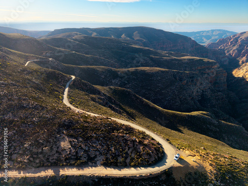 Aerial view of mountain pass with dirt road