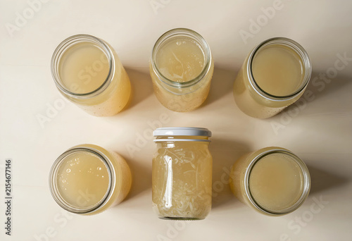 Homemade bone broth in glass mason jars, healthy cooking and natural food preparation, top view