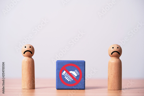 Sad wooden people with prohibited handshake symbol represent failed partnership, broken agreement, business conflict, rejected deal, disagreement, negotiation failure and end of cooperation concept.