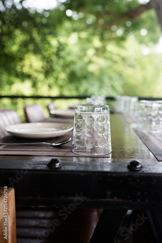 A table setting served for dinner. Selective focus empty glasses, plates on table. Beautiful summer holiday concept. Romantic time at resort.