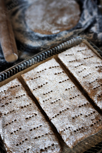 Fotografie Raw rectangular rye flatbread dough with docker holes.